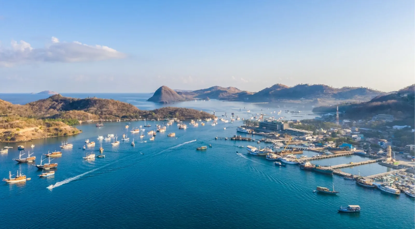 Aerial view of Labuan Bajo town, its pier and the boats moored along the waterfront