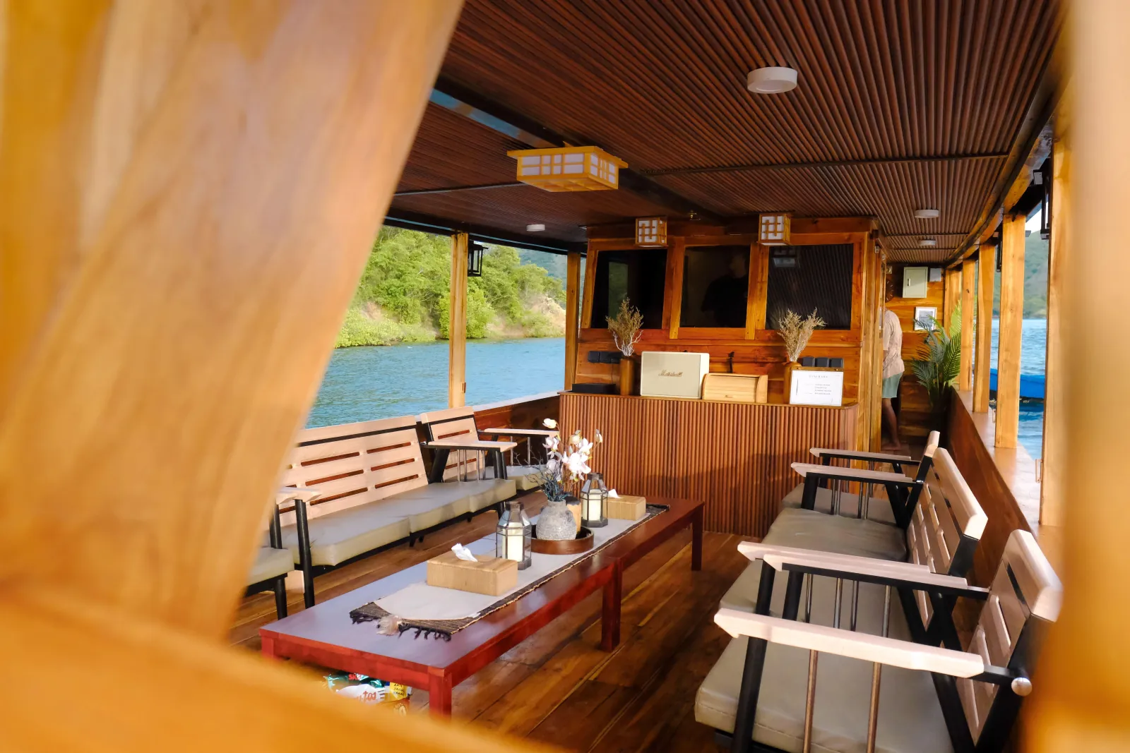 Wooden interior dining area of the open-deck boat