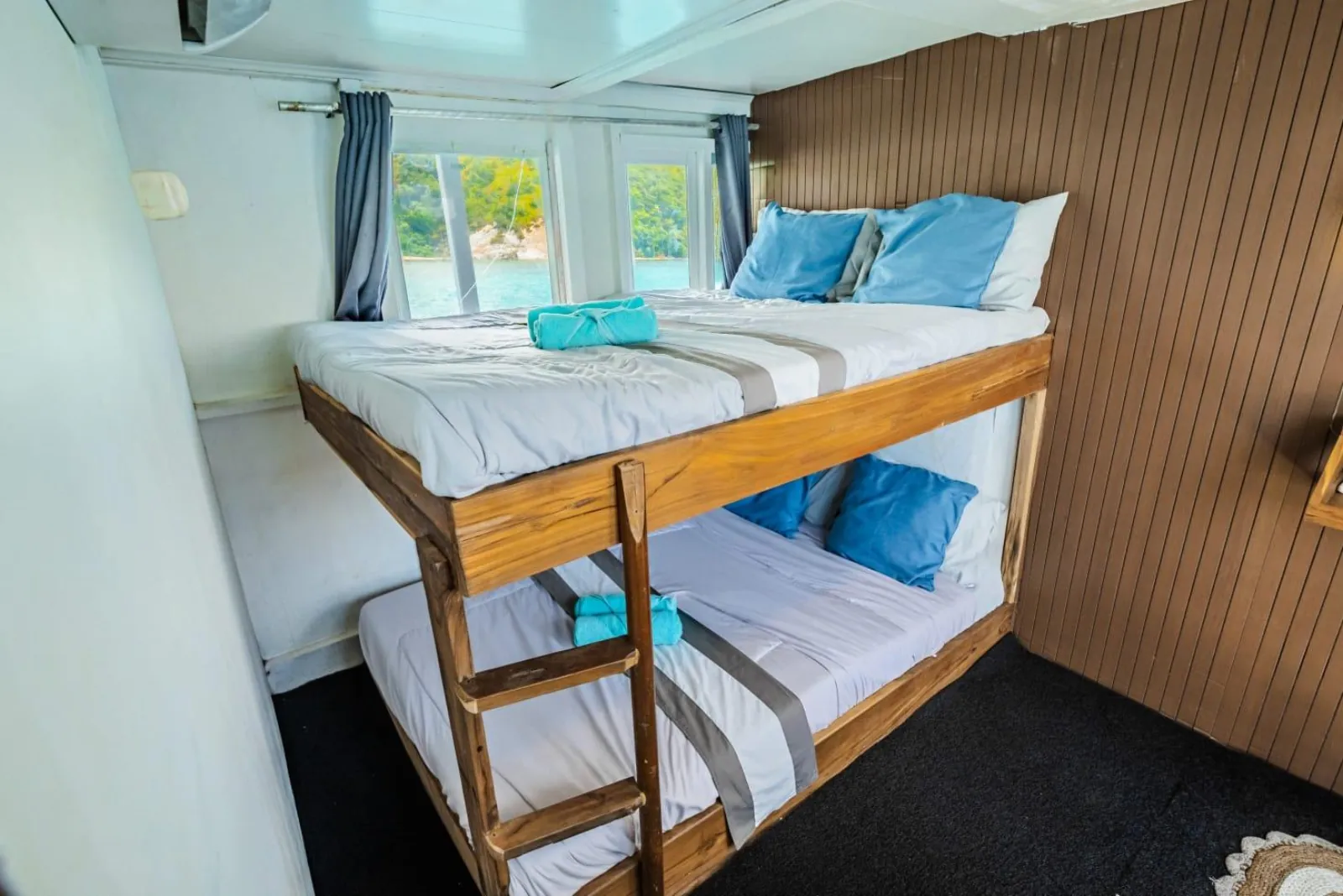Shared bunk cabin with made-up berths on the budget Komodo liveaboard