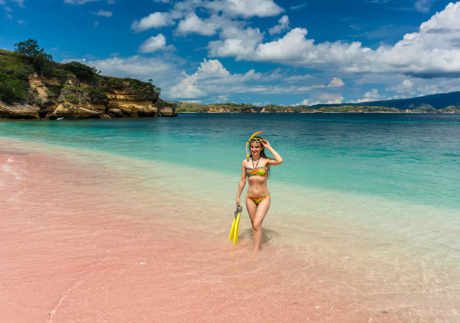 Snorkeller walking out of the shallows at Pink Beach, Komodo National Park