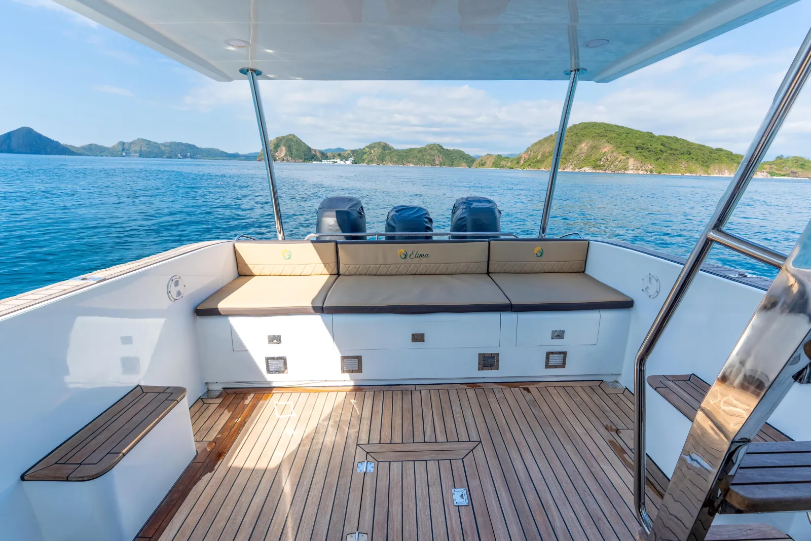 Open aft deck of the speedboat with helm seats and bench seating