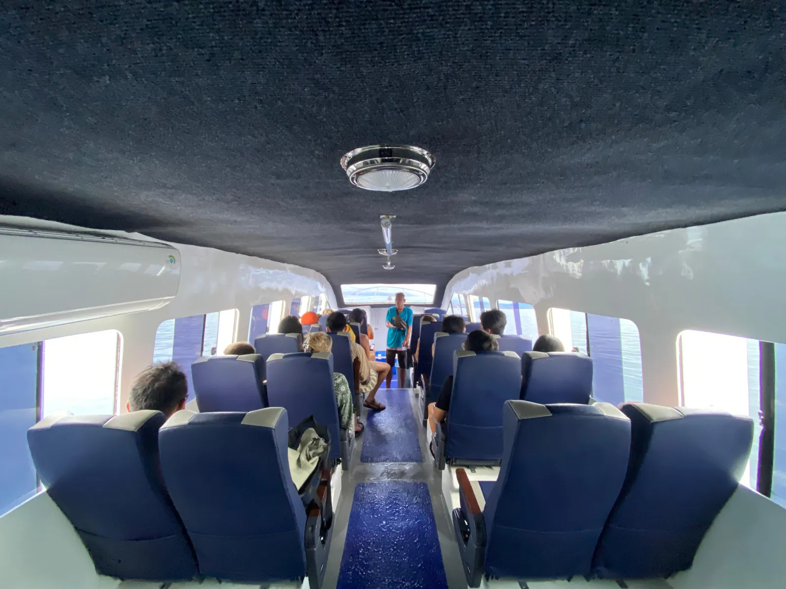 Passengers seated in the boat's covered cabin during the crossing